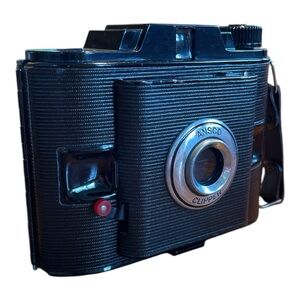 Black Film Photography Camera with Textured Body and Circular Lens